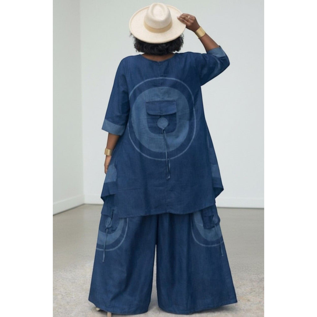 Unspoken Couture Boutique indigo blue two-piece set with tunic top and wide-leg pants, featuring contrast print details and pockets.